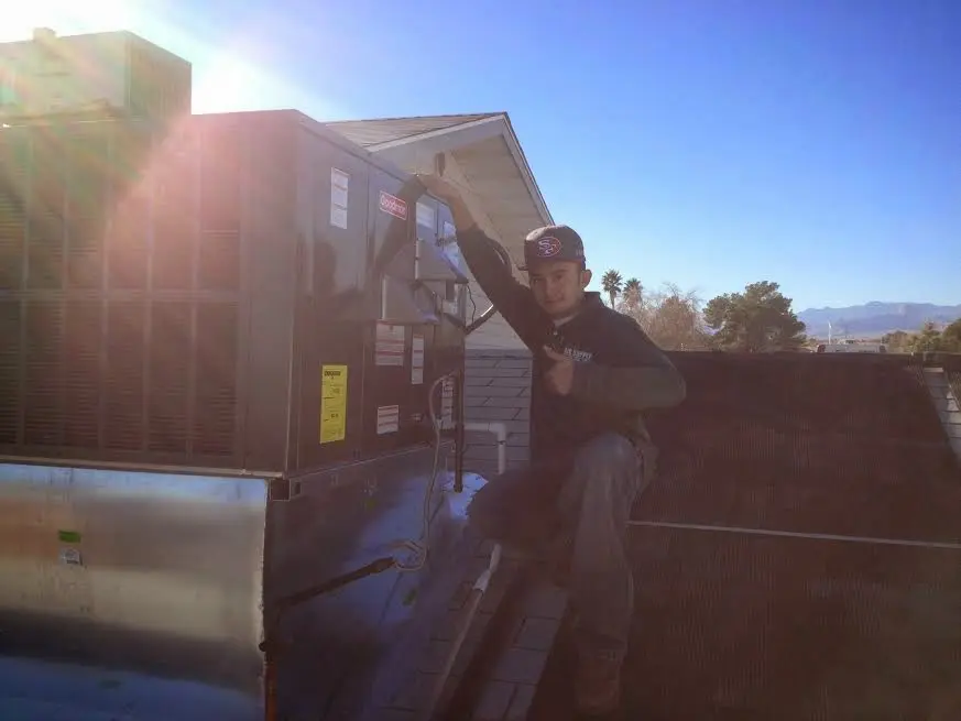 HVAC technician performing Heat Pump Repair on a rooftop unit in Benicia